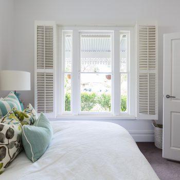 Bedroom window with a garden view in a luxury country house bedroom