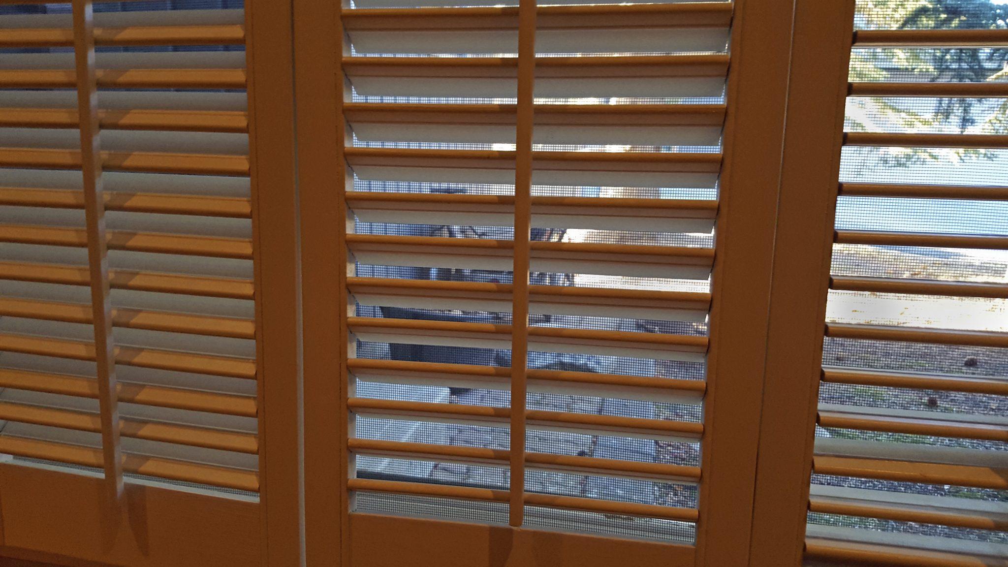 Indoor Wooden Shutters With Mesh Screen And Outdoors
